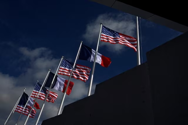 French and US flags are seen at Paris Orly airport near Paris on June 5, 2024. JULIEN DE ROSA/Pool via REUTERS/File Photo