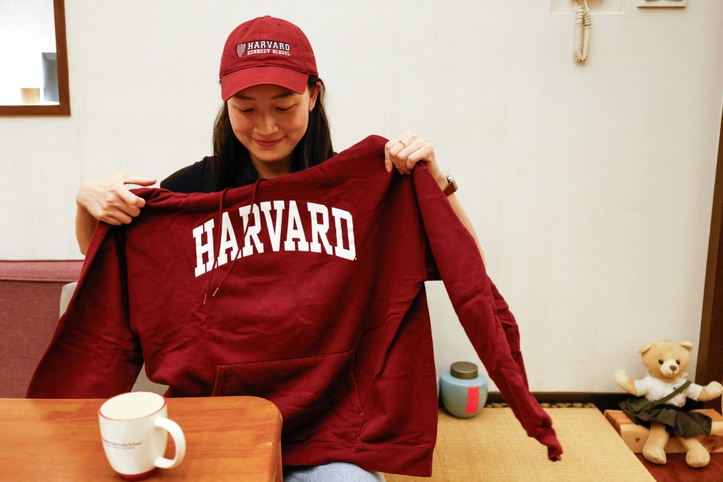 Lin, 27, poses for a photo with a Harvard hat and hoodie in Taipei, Taiwan May 24, 2025. (Reuters)