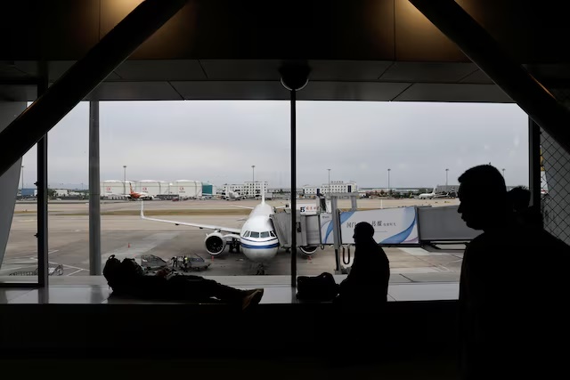 Passengers wait for their flights at the Beijing Capital International Airport, in Beijing, China April 20, 2024. REUTERS/Tingshu Wang/File Photo