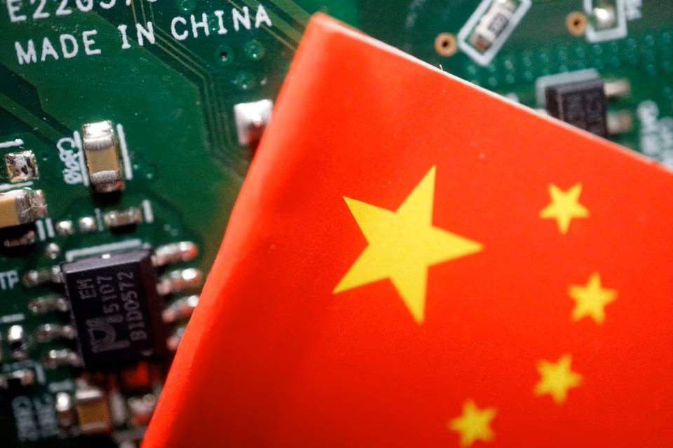 A Chinese flag is displayed next to a 'Made in China' sign seen on a printed circuit board with semiconductor chips, in this illustration. (Reuters) A Chinese flag is displayed next to a 'Made in China' sign seen on a printed circuit board with semiconductor chips, in this illustration. (Reuters)