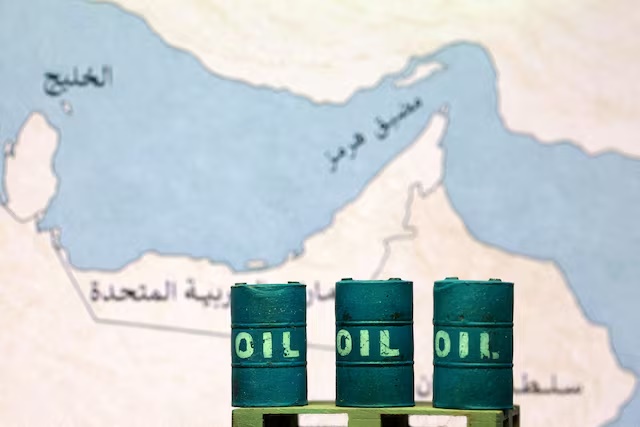 A map showing the Strait of Hormuz, also known as Madiq Hurmuz, and 3D printed oil barrels are seen in this illustration taken March 26, 2026. REUTERS/Dado Ruvic/Illustration