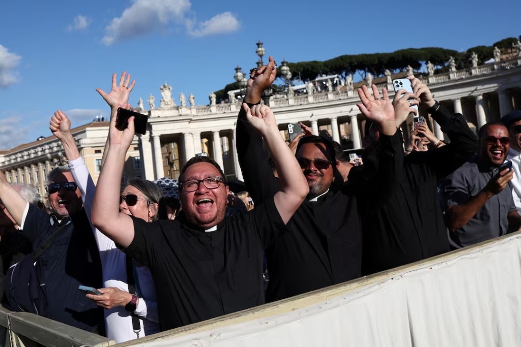 Faithful react to the white smoke indicating that a new pope has been elected, at the Vatican, May 8, 2025. (Reuters)