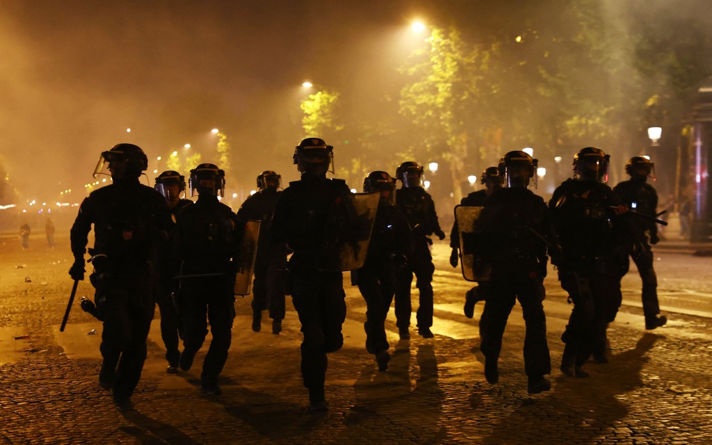 Riot police on the Champs Elysees avenue after Paris St Germain won the Champions League. (Reuters)