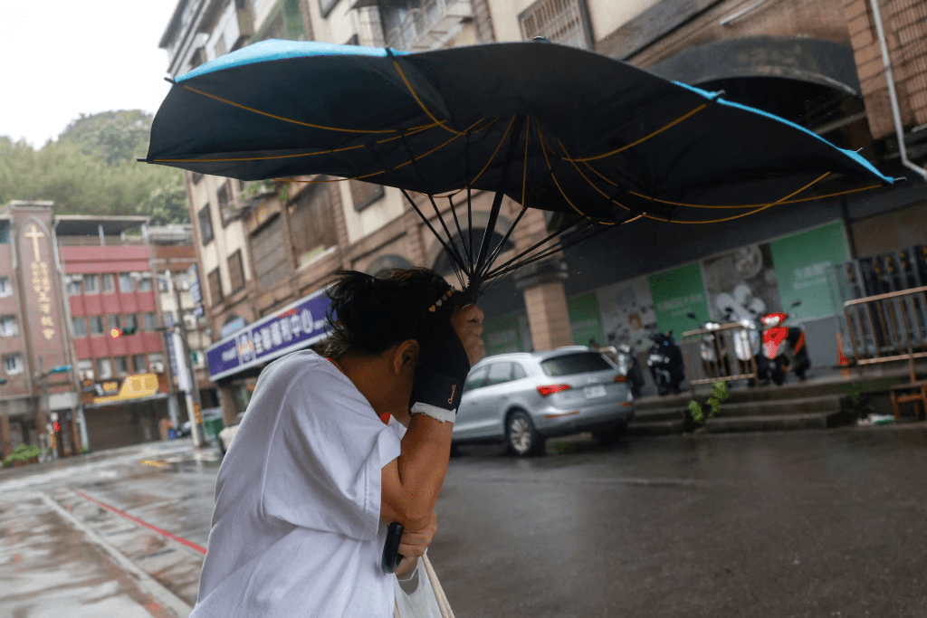 A pedestrian holds an umbrella as Typhoon Champi approaches Taiwan, in Keelung, Taiwan, October 23, 2026. REUTERS/Ann Wang