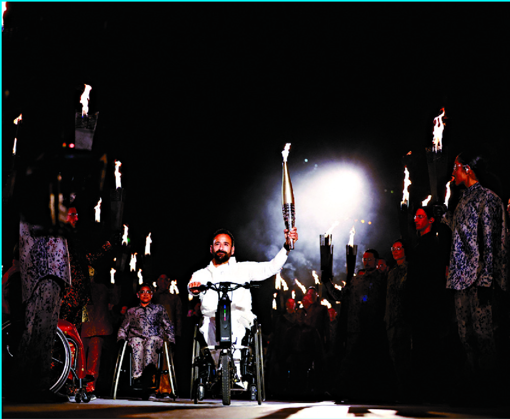 Frenchman Michael Jeremiasz carries the flame. REUTERS Frenchman Michael Jeremiasz carries the flame. REUTERS