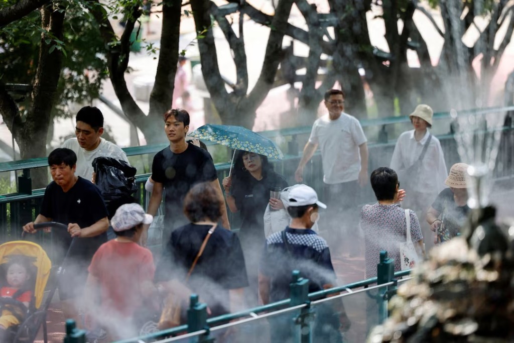 Visitors walk through a cooling mist system at Gwangmyeong Cave during a record-breaking heatwave in Gwangmyeong, South Korea, August 5, 2026, after Yangsan recorded the highest temperature in the country in 122 years of weather observations on Sunday. REUTERS/Kim Soo-hyeon