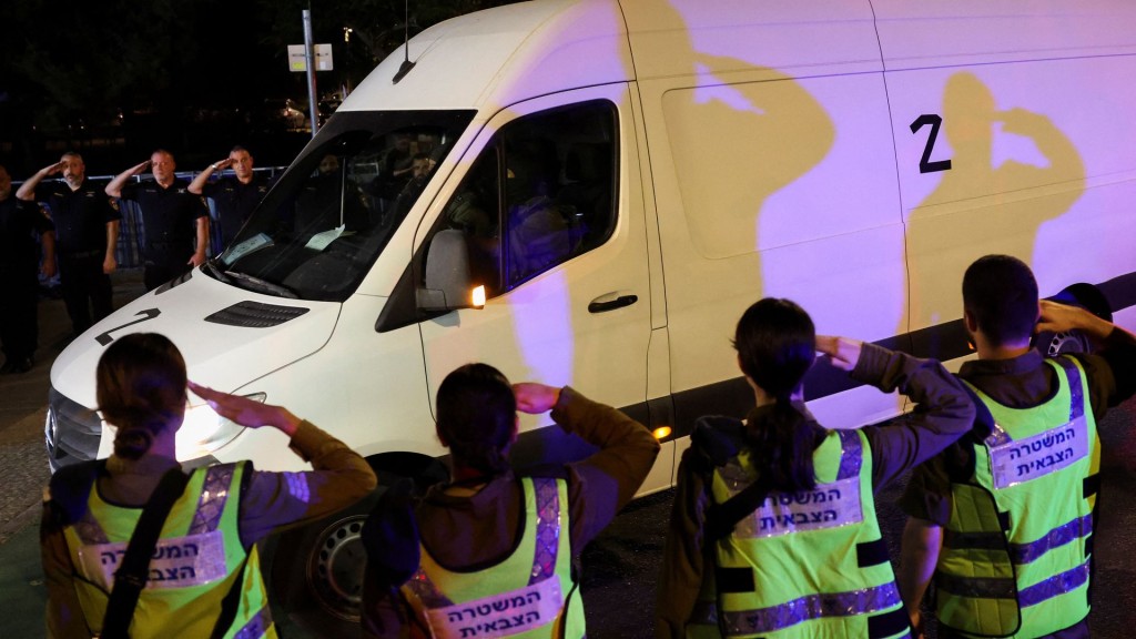 A convoy transporting the bodies of deceased hostages arrives at Abu Kabir forensic centre. (Reuters)