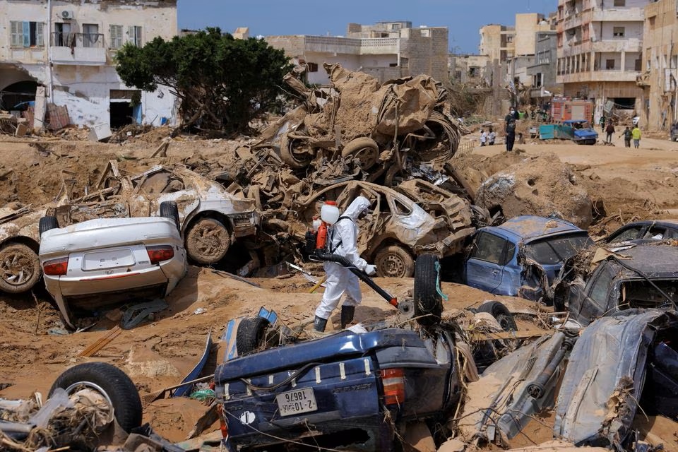 A sanitation worker disinfects rubble, amid rising concerns of spread of infectious diseases, as dead bodies started to decompose, following fatal floods in Derna, Libya, September 17. (Reuters) A sanitation worker disinfects rubble, amid rising concerns of spread of infectious diseases, as dead bodies started to decompose, following fatal floods in Derna, Libya, September 17. (Reuters)