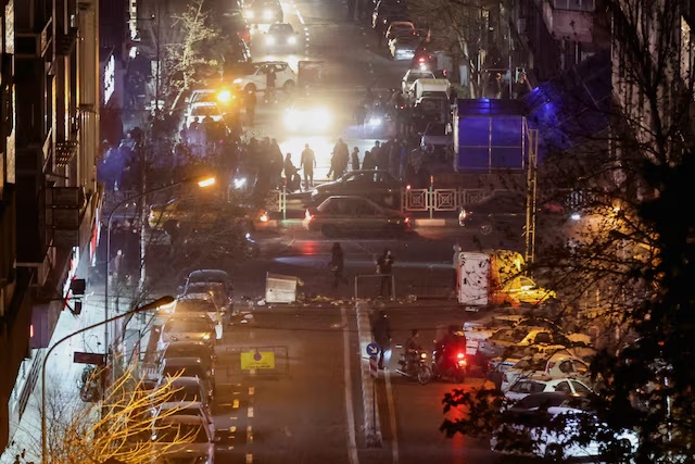 Iranian demonstrators gather in a street during a protest over the collapse of the currency's value, in Tehran, Iran, January 8, 2026. Stringer/WANA (West Asia News Agency) via REUTERS 