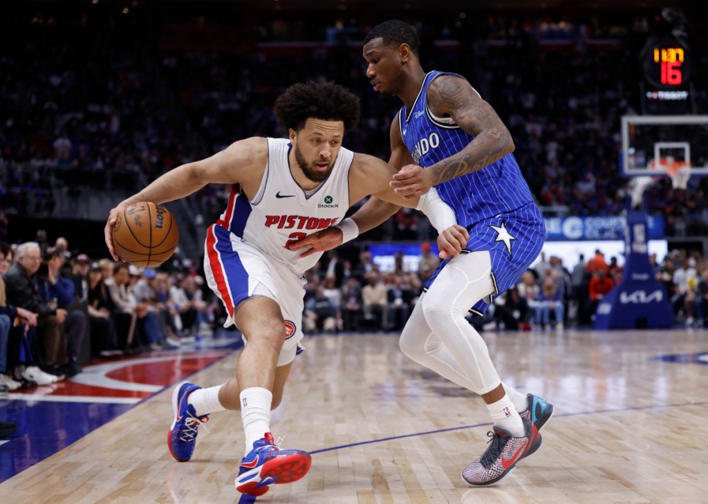 Cade Cunningham tries to get past Orlando Magic forward Jamal Cain. REUTERS