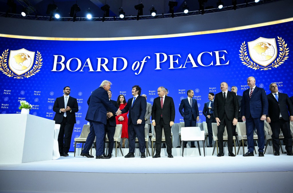 Photo by MANDEL NGAN / AFP  US President Donald Trump (2L) shakes hands with Argentina's President Javier Milei at the "Board of Peace" meeting during the World Economic Forum (WEF) annual meeting in Davos on January 22, 2026.