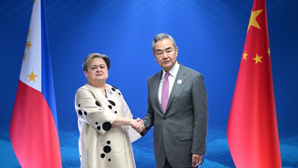 Philippine Foreign Secretary Theresa Lazaro shakes hands with China's Foreign Minister Wang Yi. Reuters