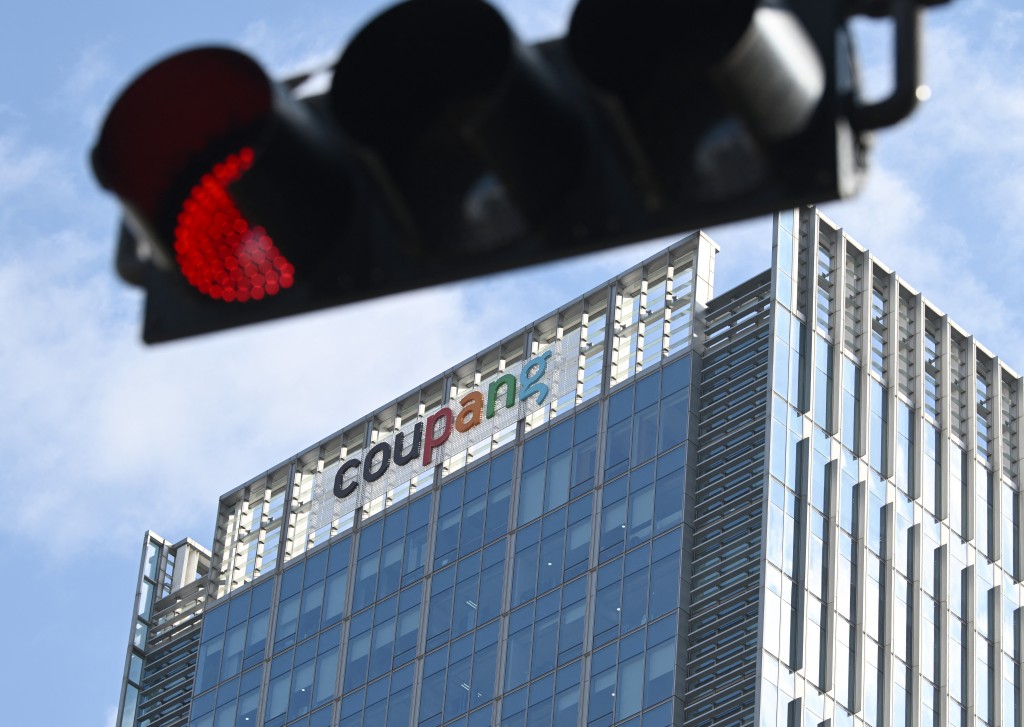 Photo by JUNG YEON-JE / AFP  A general view shows the logo of South Korean online delivery service Coupang, at a building housing the company's headquarters in Seoul on December 9, 2025.