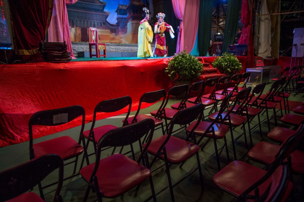 Incense sticks and joss paper are burned as an offering to the afterlife, while an opera troupe performs – the vacant front-row seats serving as invitations and reminders that unseen guests are part of the audience. XINHUA