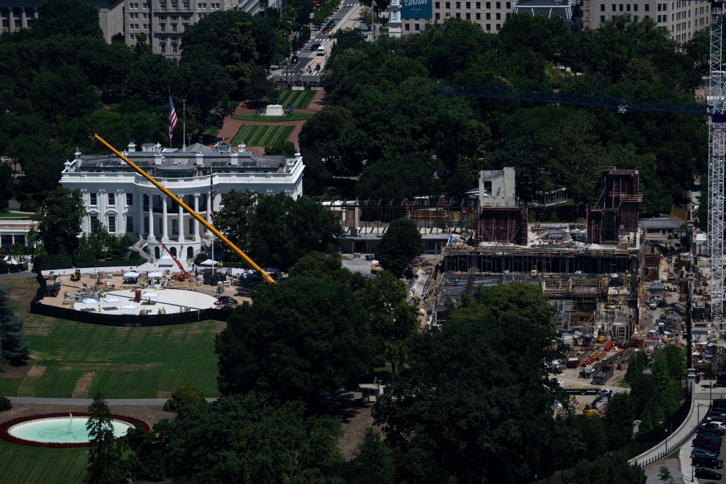 Photo by KENT NISHIMURA / AFP  A view of the ongoing construction of a helipad (L) and ballroom (R) at the White House, as seen from the Washington Monument observation deck in Washington, DC on July 23, 2026.