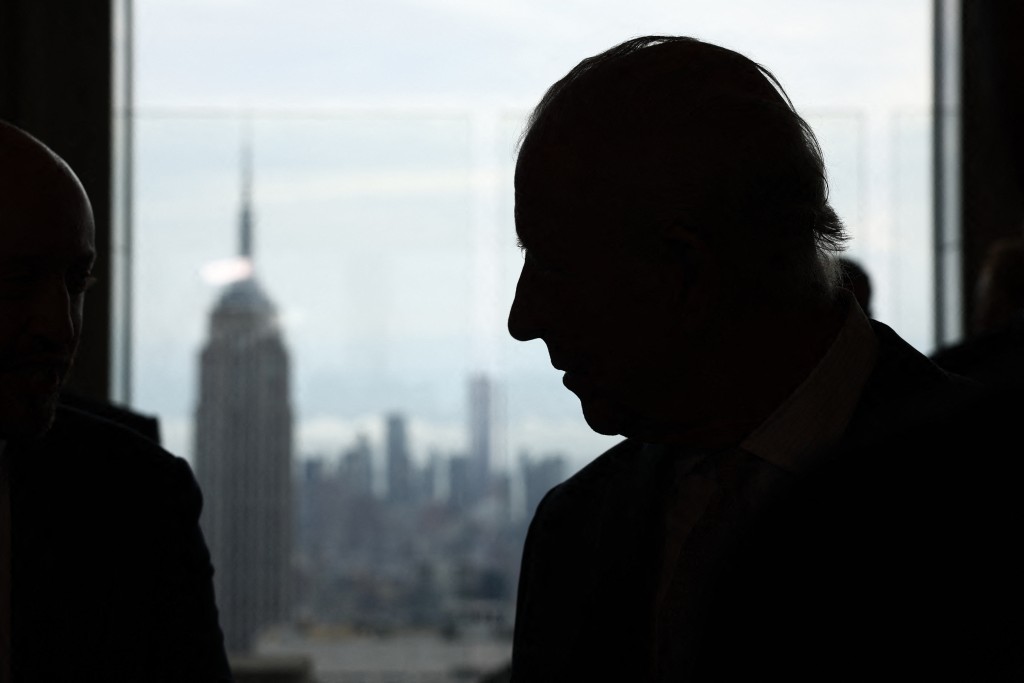 The Empire State Building is seen in the distance as Britain's King Charles III speaks to attendees during a UK-US Trade Event at Rockefeller Center in New York on April 29, 2026. (Photo by Henry Nicholls / POOL / AFP)