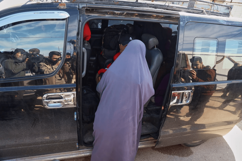Family members of suspected Islamic State militants who are Australian nationals board a van heading to the airport in Damascus during the first repatriation operation of the year, at Roj Camp in eastern Syria, Monday, Feb. 16, 2026. Thirty-four Australian citizens from 11 families departed the camp. (AP Photo/Baderkhan Ahmad)