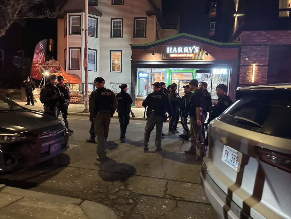 Police officers gather near the site of a mass shooting reported by authorities at Brown University in Providence, Rhode Island, U.S. December 13, 2025. (REUTERS/Taylor Coester)