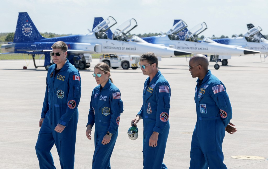 The Artemis II crew – (L-R) mission specialist Jeremy Hansen of CSA (Canadian Space Agency), mission specialist Christina Koch, commander Reid Wiseman and pilot Victor Glover – walk together after arriving at the Kennedy Space Center on March 27, 2026 in Cape Canaveral, Florida. The astronauts arrived to begin preparations for an April 1, 2026 launch for a 10-day mission, which will take them around the Moon and back to Earth. Joe Raedle/Getty Images/AFP