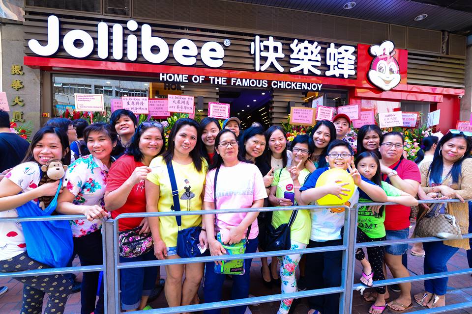 People standing in front of a Jollibee store. JOLLIBEE HK FACEBOOK