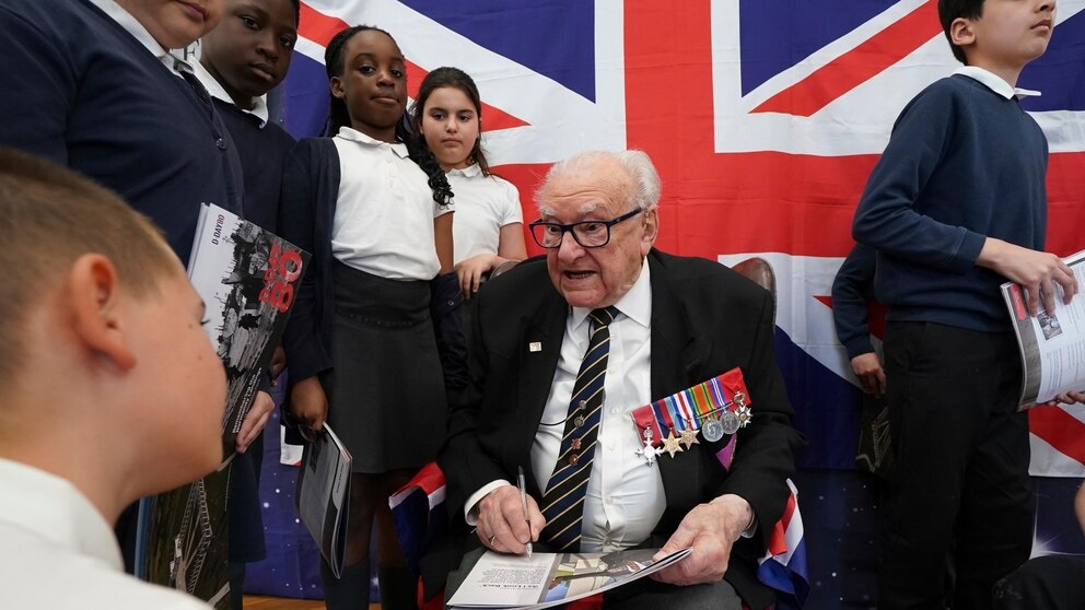 D-Day veteran and Ambassador for the British Normandy Memorial, Ken Hay, 98, who served with the 4th Dorset Regiment, speaks to children during a visit to Rush Green Primary School in Dagenham, England, Monday May 20, 2024, ahead of the 80th anniversary of the D-Day landings. (Gareth Fuller/PA via AP) D-Day veteran and Ambassador for the British Normandy Memorial, Ken Hay, 98, who served with the 4th Dorset Regiment, speaks to children during a visit to Rush Green Primary School in Dagenham, England, Monday May 20, 2024, ahead of the 80th anniversary of the D-Day landings. (Gareth Fuller/PA via AP)