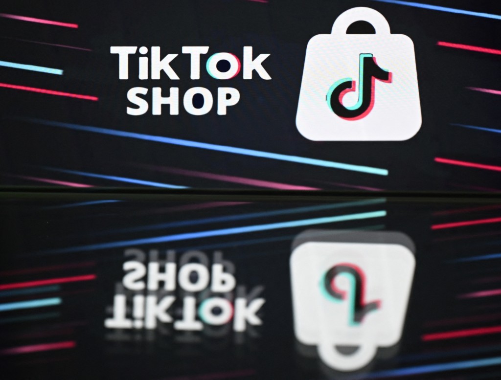 Photo by JUSTIN TALLIS / AFP  This photo illustration taken on April 17, 2025 shows the TikTok logo displayed on a screen at a residential property in Guildford, south of London.