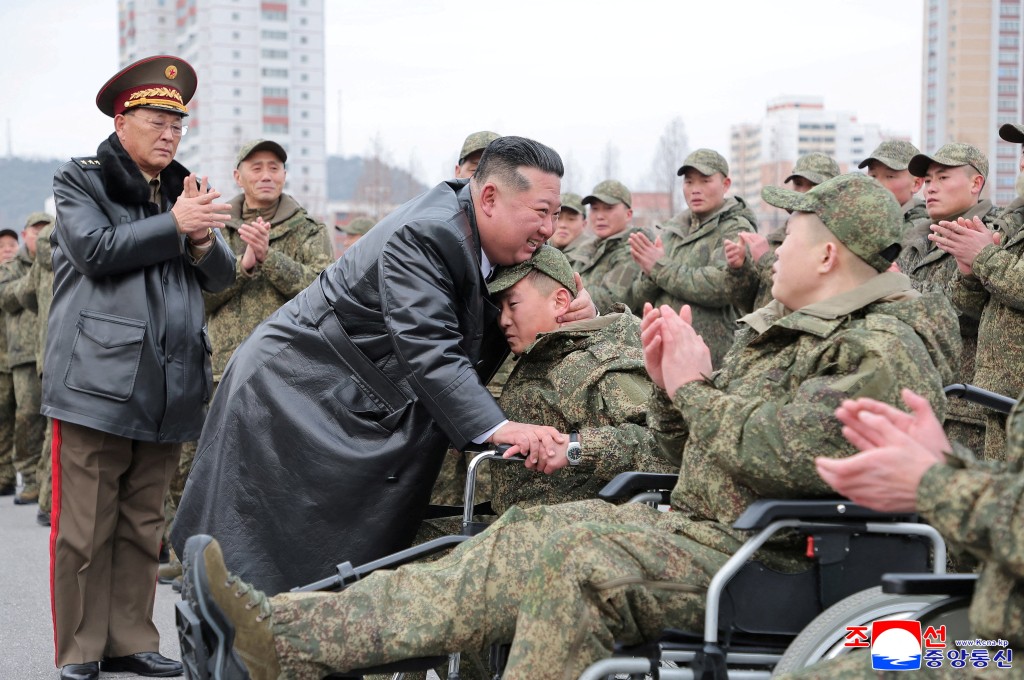 North Korean leader Kim Jong Un embraces a soldier during a welcoming ceremony for members of the 528th Engineer Regiment after they returned from an overseas mission, at the April 25 Cultural and Tourism Center in Pyongyang, North Korea, December 12, 2025, in this picture released by North Korea's official Korean Central News Agency on December 13, 2025. REUTERS/KCNA KCNA via REUTERS