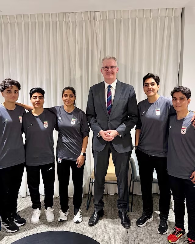 Australia's Home Affairs Minister Tony Burke poses with Fatemeh Pasandideh, Mona Hamoudi, Atefeh Ramezanizadeh, Zahra Ghanbari and Zahra Sarbali, the five women from the Iranian women’s soccer team who were granted humanitarian visas, in Queensland, Australia, March 9, 2026. @Tony_Burke on X/Handout via REUTERS