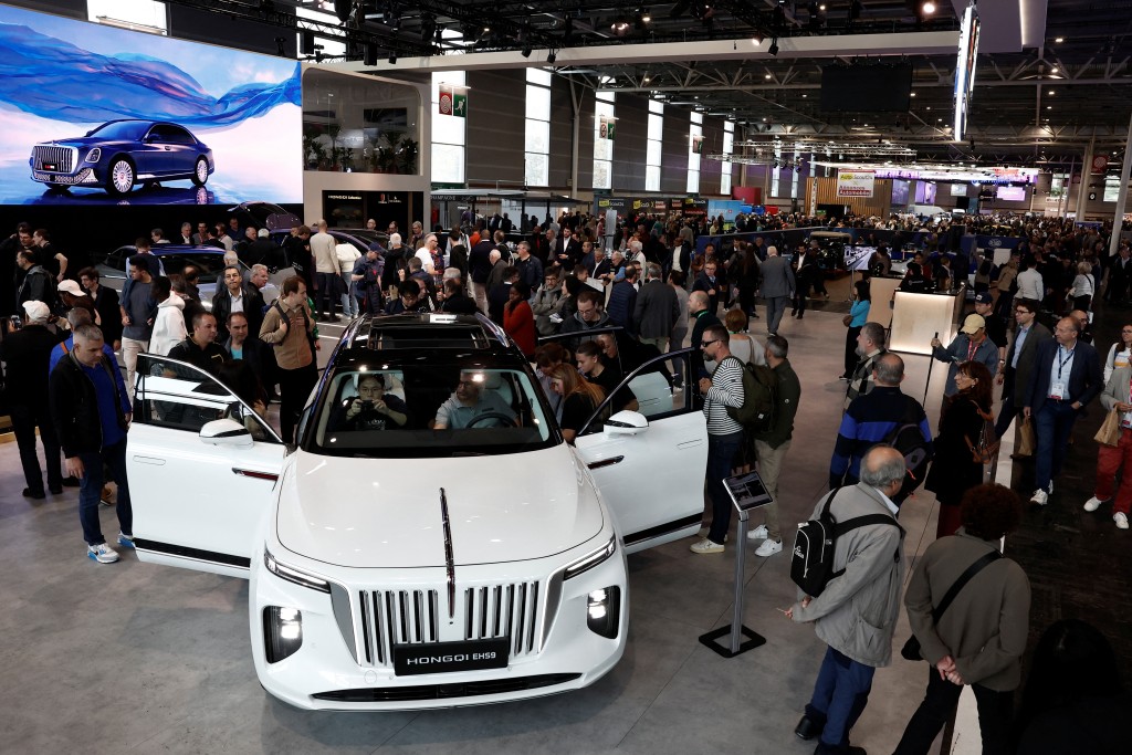 Visitors inspect a Hongqi E-HS9 luxury car at the 2024 Paris Auto Show in Paris, France, October 15, 2024. REUTERS/Benoit Tessier