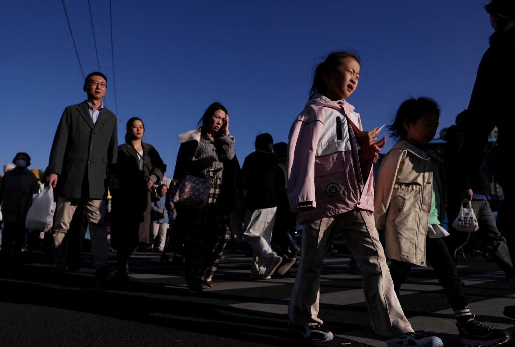 People walk on a street in Beijing, China October 19, 2025. REUTERS
