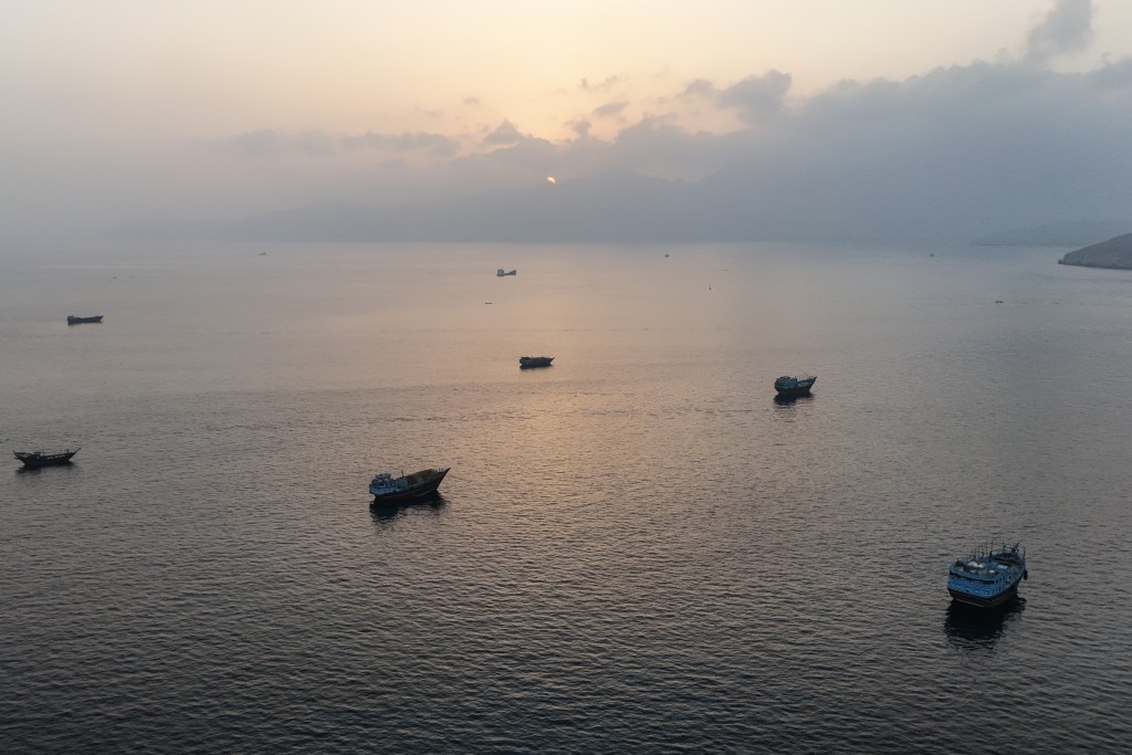 Photo by - / AFP  This aerial photograph shows boats anchored off Oman’s northern Musandam Peninsula near the Strait of Hormuz on June 27, 2026.