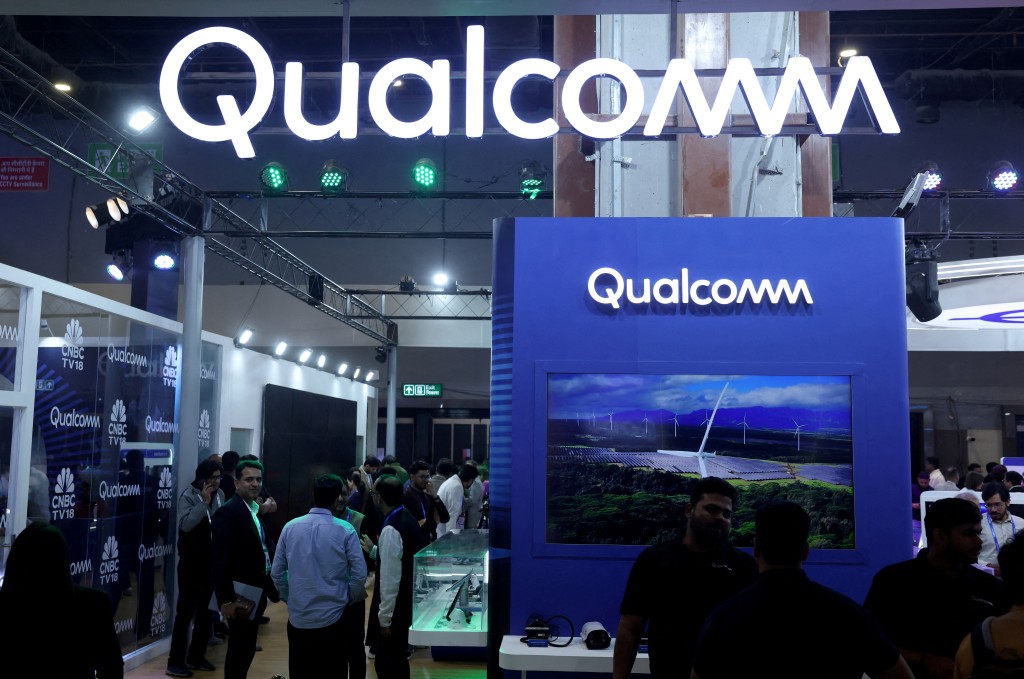 Visitors stand at the Qualcomm kiosk at Bharat Mandapam, one of the venues for AI Impact Summit, in New Delhi, India, February 18, 2026. REUTERS