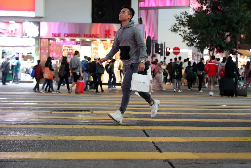 A shopper runs across the road in Causeway Bay in December 2019. Photo by REUTERS