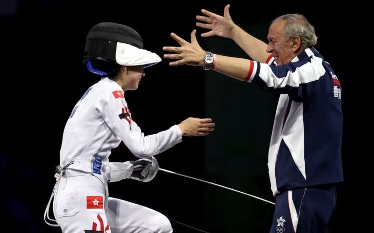 Vivian Kong Man-wai celebrates with her coach Octavian Zidaru after winning the gold medal. (Reuters)