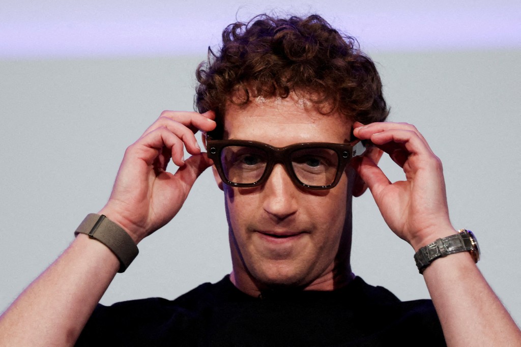Meta CEO Mark Zuckerberg wears the Meta Ray-Ban Display glasses, as he delivers a speech presenting the new line of smart glasses, during the Meta Connect event at the company's headquarters in Menlo Park, California, U.S., September 17, 2025. REUTERS/Carlos Barria