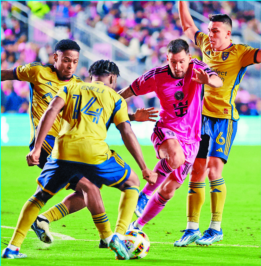 Lionel Messi maneuvers his way against three Real Salt Lake players. AFP Lionel Messi maneuvers his way against three Real Salt Lake players. AFP