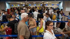 Tourists wait for departing planes at the airport, after being evacuated following a wildfire on the island of Rhodes, Greece, July 24, 2023. REUTERS/Nicolas Economou Tourists wait for departing planes at the airport, after being evacuated following a wildfire on the island of Rhodes, Greece, July 24, 2023. REUTERS/Nicolas Economou