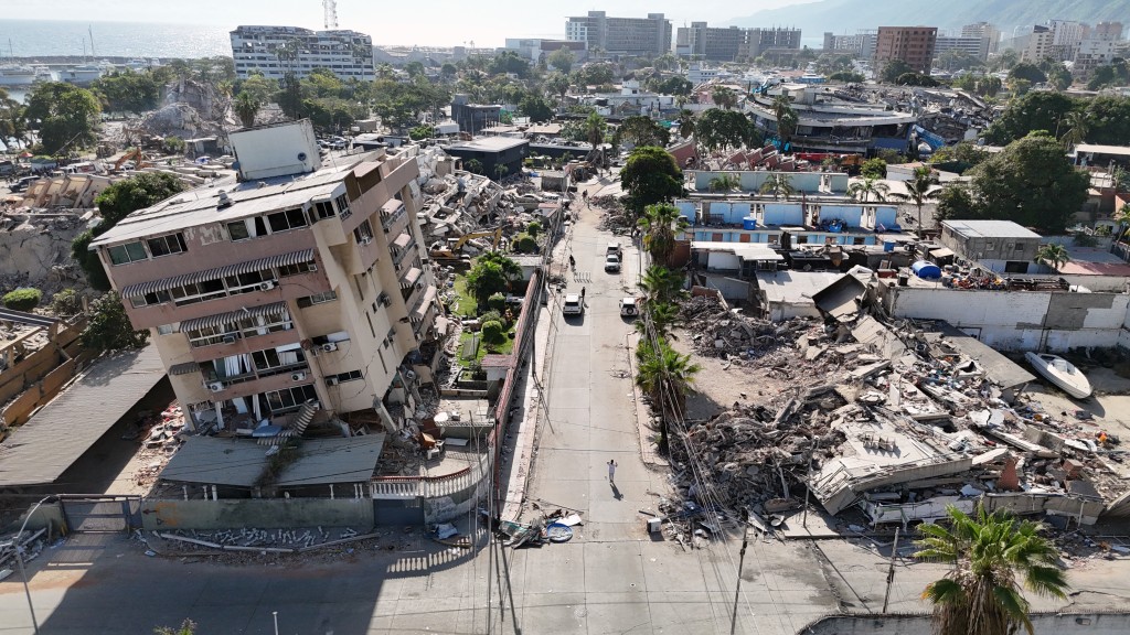 Photo by YORMAN MALDONADO / AFP. This aerial view shows a heavily damaged coastal area with collapsed buildings and debris following the June 24 twin earthquakes in Caraballeda, La Guaira State, Venezuela, on June 29, 2026.