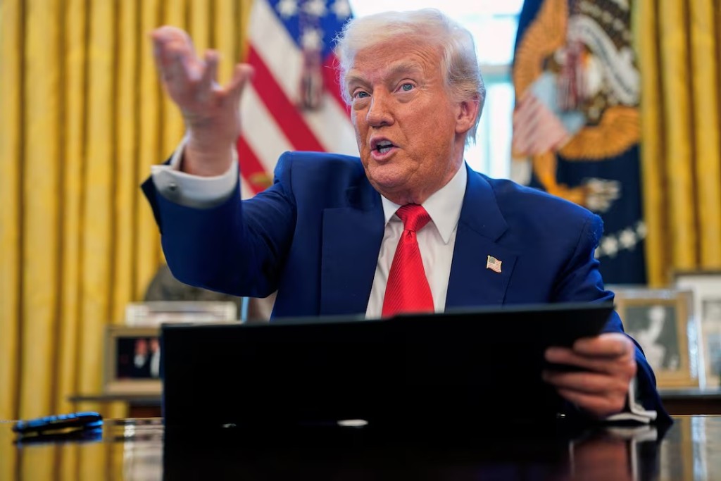 U.S. President Donald Trump speaks, as he signs executive orders and proclamations in the Oval Office at the White House in Washington, D.C., U.S., April 9, 2025. REUTERS/Nathan Howard