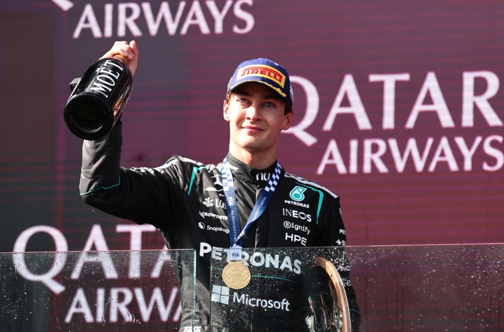 George Russell celebrates on the podium after winning the Australian Grand Prix. REUTERS 