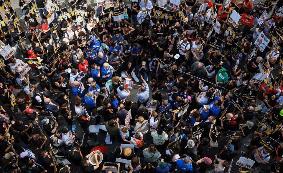 Actors, writers and other union members gather around a speaker as SAG-AFTRA and WGA strikers demonstrate in Manhattan in New York. (Reuters) Actors, writers and other union members gather around a speaker as SAG-AFTRA and WGA strikers demonstrate in Manhattan in New York. (Reuters)
