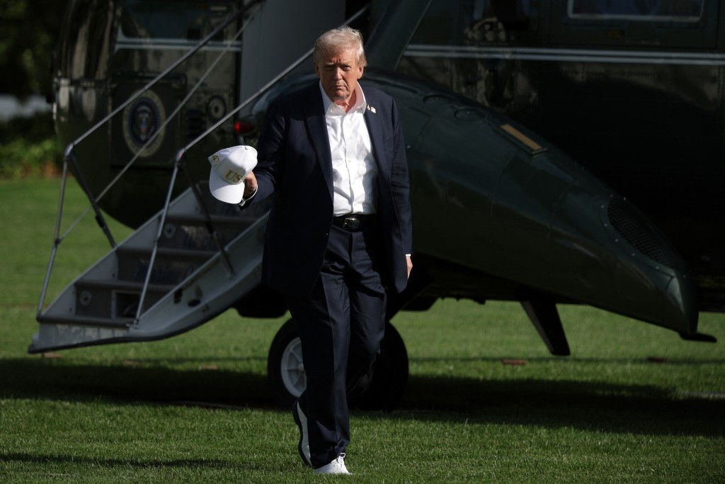 U.S. President Donald Trump walks on the South Lawn after he landed back at the White House during a Marine One arrival on September 26, 2025 in Washington, DC. (AFP)