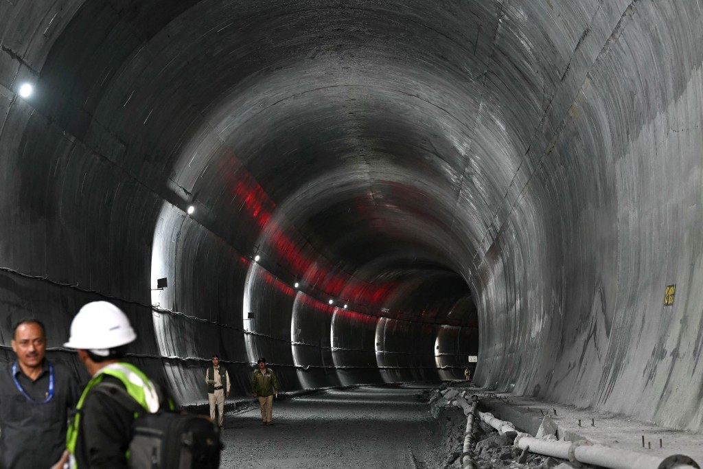Indian police personnel stand guard at the Zojila tunnel, India's longest road tunnel project connecting Jammu and Kashmir state with the Ladakh region on June 9, 2026. (Photo by TAUSEEF MUSTAFA / AFP)