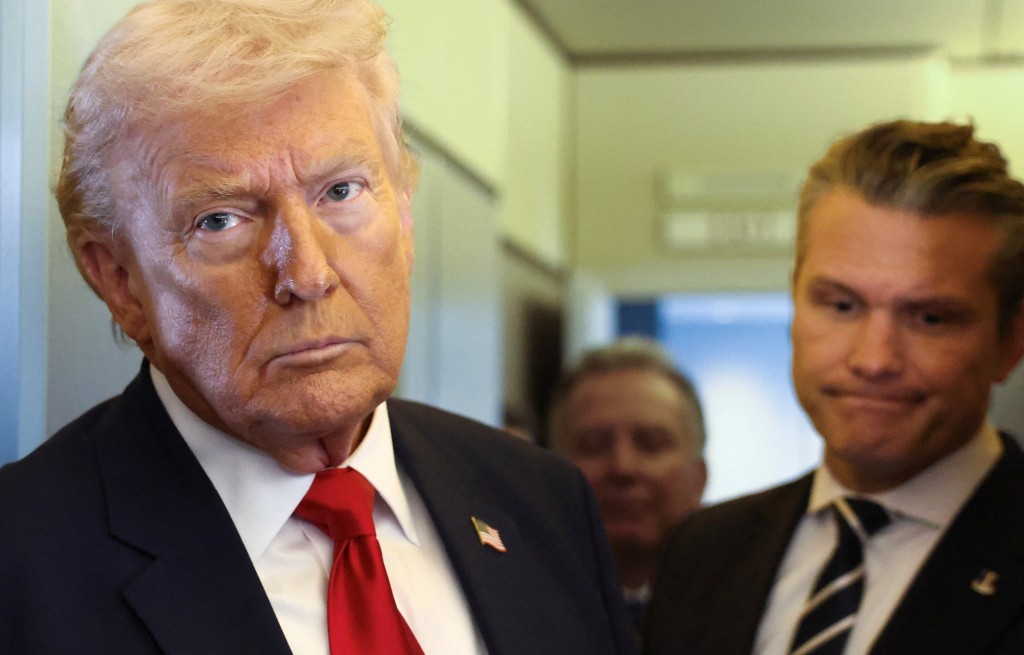 U.S. President Donald Trump, with Secretary of Defense Pete Hegseth at his side, looks on as he speaks to reporters aboard Air Force One on a flight from Dover, Delaware, to Miami, Florida, U.S., March 7, 2026. (Reuters)