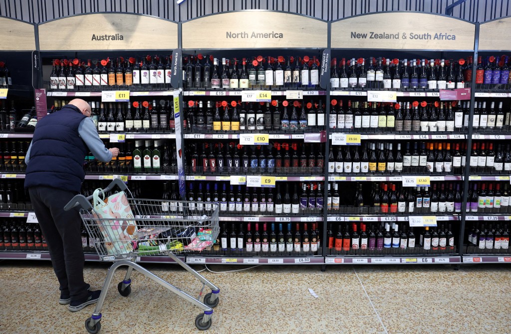 A shopper browses in the red wines section at a Tesco Extra supermarket in Cheshunt, Britain, March 25, 2025. Picture provided by REUTERS.