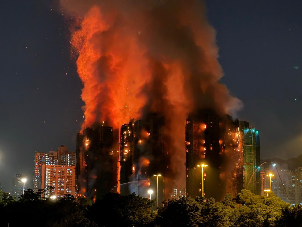 Photo by YAN ZHAO / AFP  Thick smoke and flames rise as a major fire engulfs several apartment blocks at the Wang Fuk Court residential estate in Hong Kong's Tai Po district on November 26, 2025.