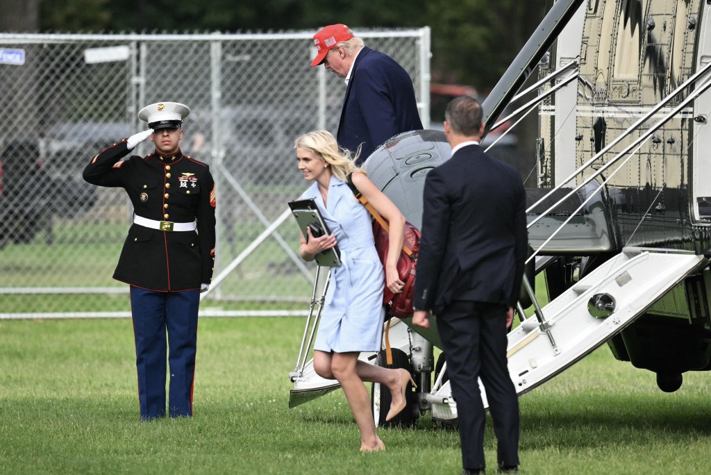 Photo by MANDEL NGAN / AFP  US President Donald Trump and aide Natalie Harp exit Marine One on the Ellipse near the White House on August 16, 2026.