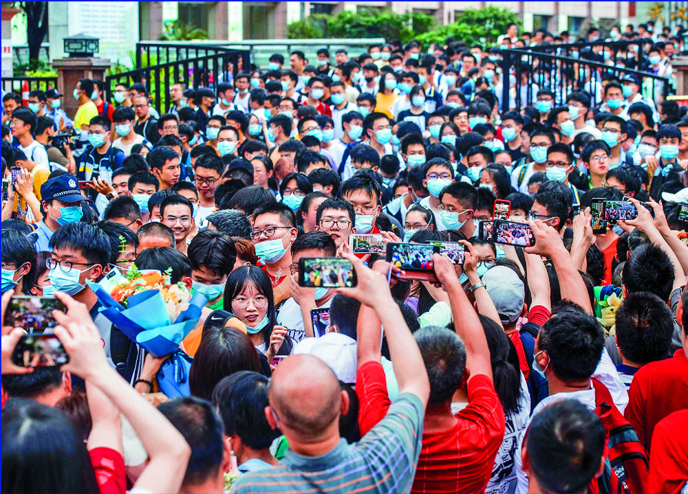 Students are cheered on as they leave a school after sitting the gaokao exam in Wuhan. AFP