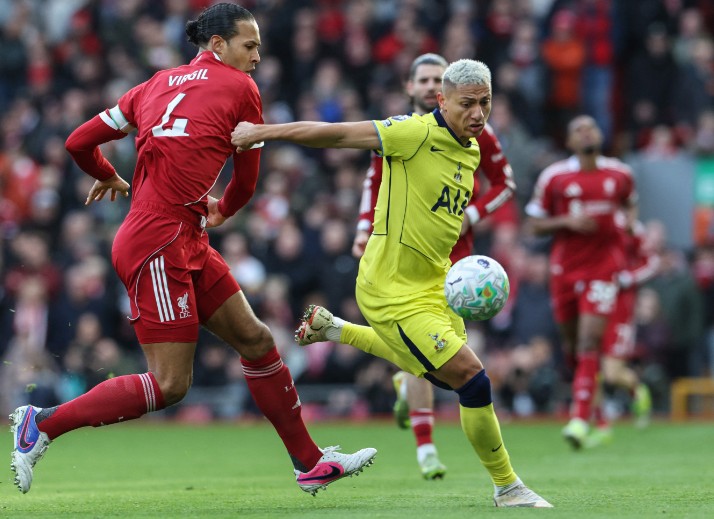 Richarlison fights off Virgil Van Dijk during the match at Anfield. AFP