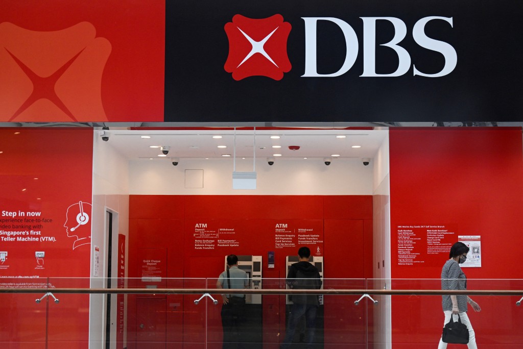 People use DBS automated teller machines (ATMs) in Singapore March 31, 2022. REUTERS